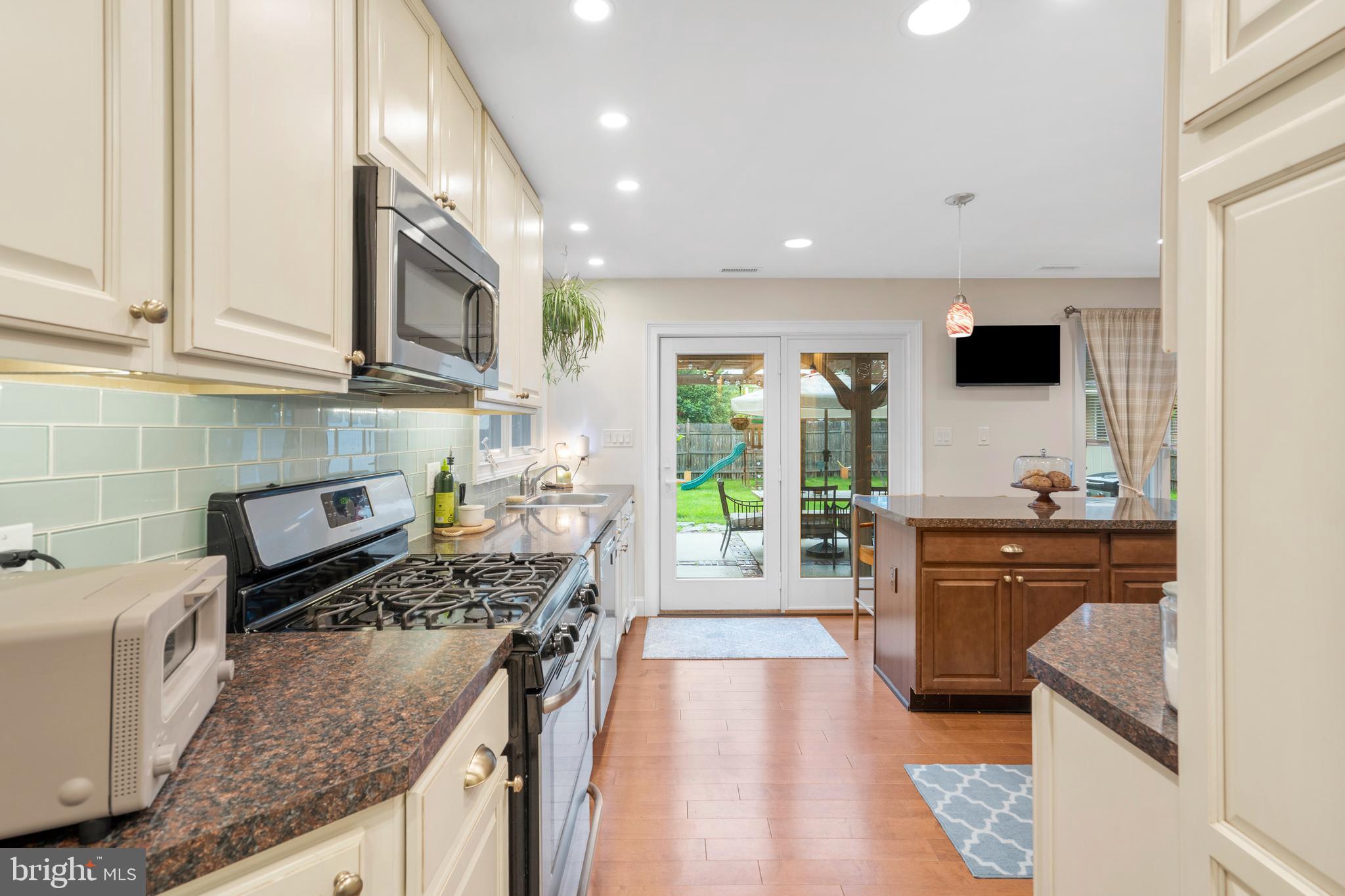 29 Concord Road Marlton, NJ 08053 - Photo 23 of 49 a kitchen with stainless steel appliances granite countertop a stove a sink and a microwave