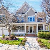 a front view of a house with garden and porch
