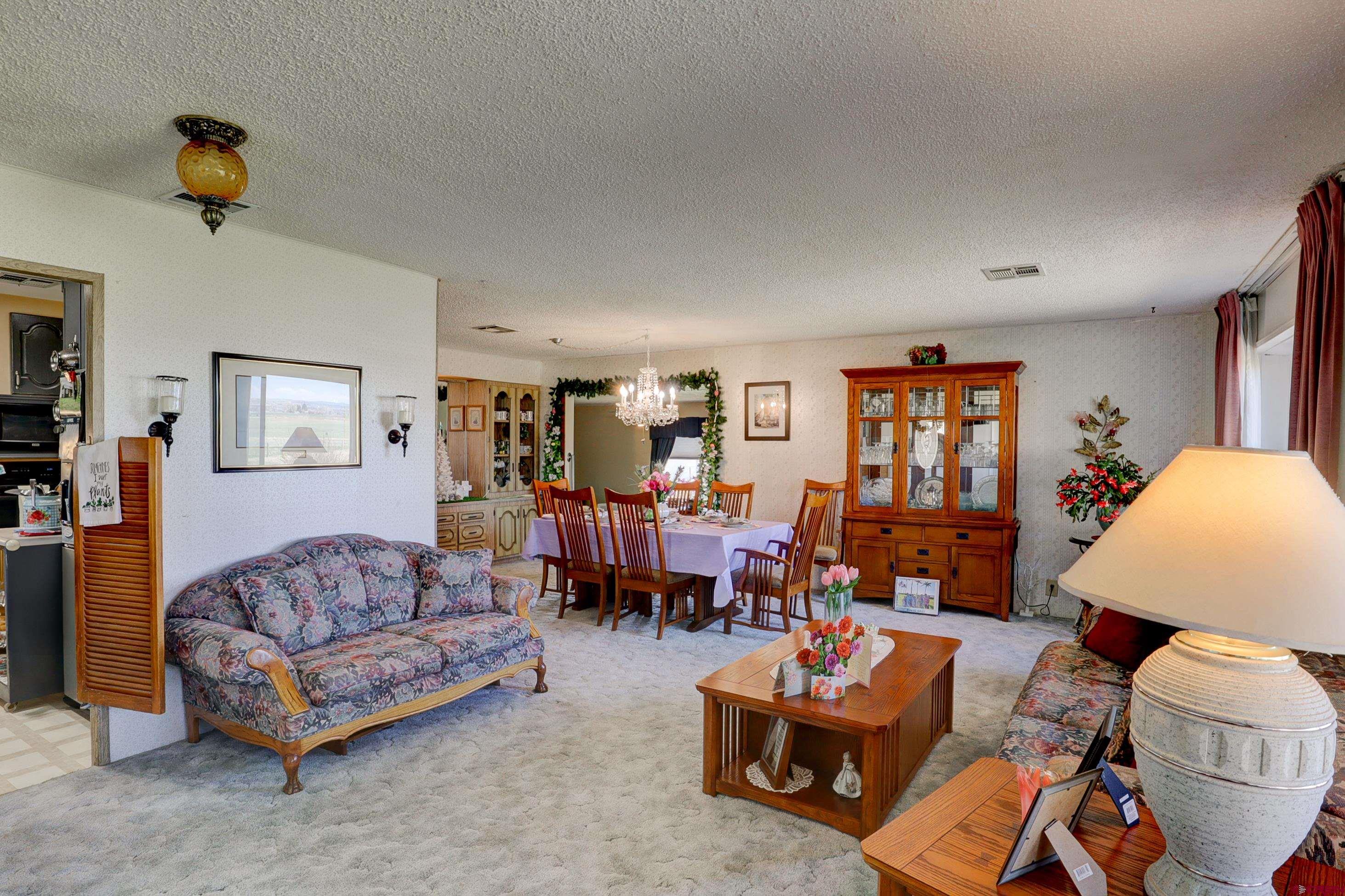 22705 Rd L Cortez, CO 81321 - Photo 12 of 30 a living room with furniture and a wooden floor