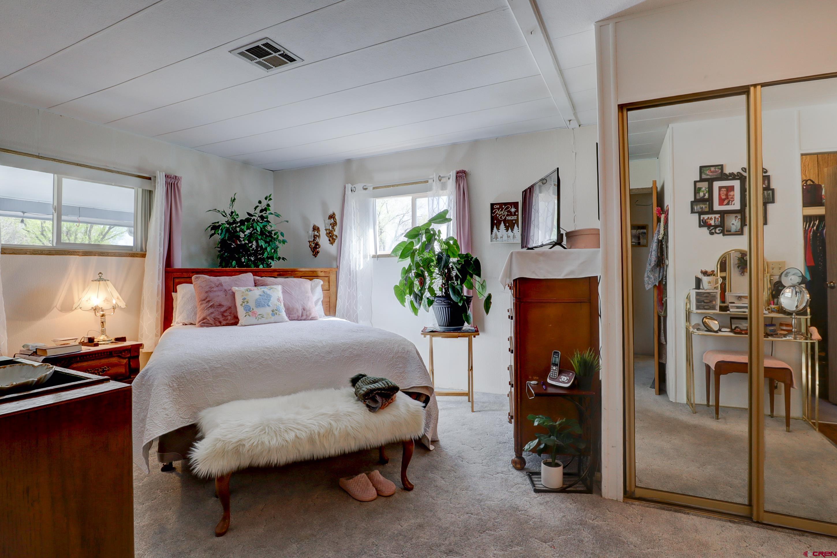 22705 Rd L Cortez, CO 81321 - Photo 14 of 30 a bedroom with a bed and a potted plant