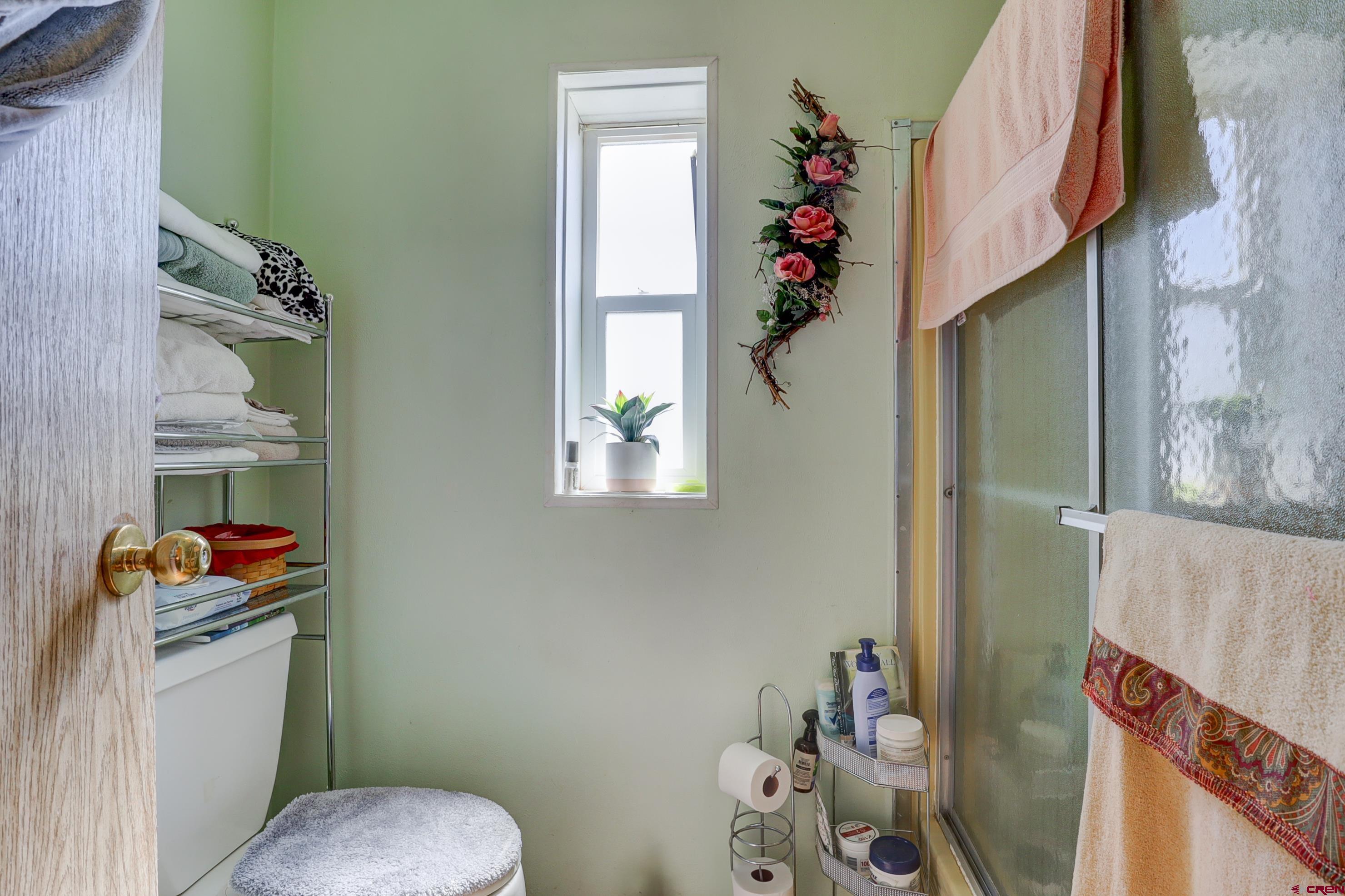 22705 Rd L Cortez, CO 81321 - Photo 16 of 30 a bathroom with a toilet sink and curtain