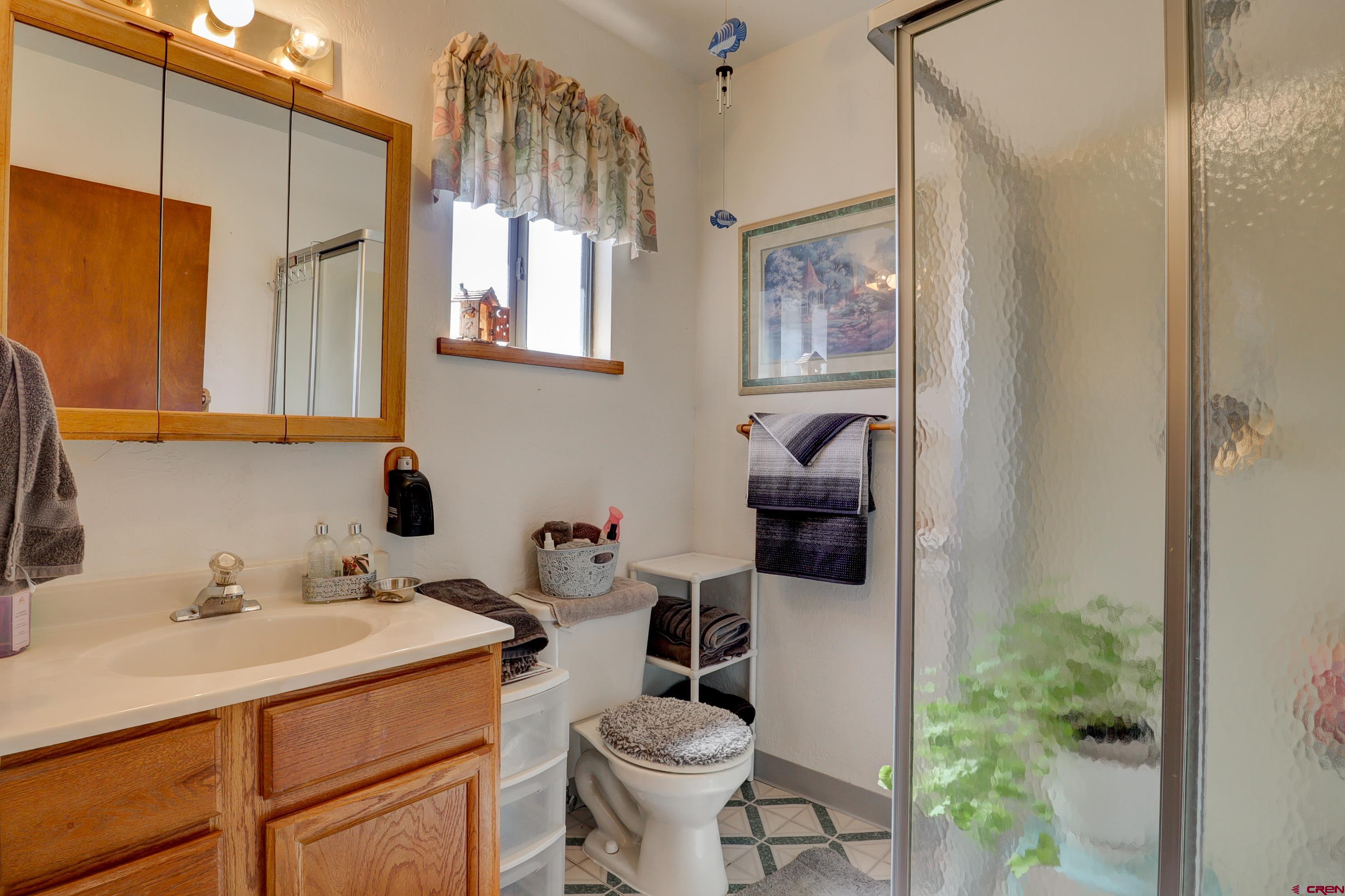22705 Rd L Cortez, CO 81321 - Photo 20 of 30 a bathroom with a sink and a mirror