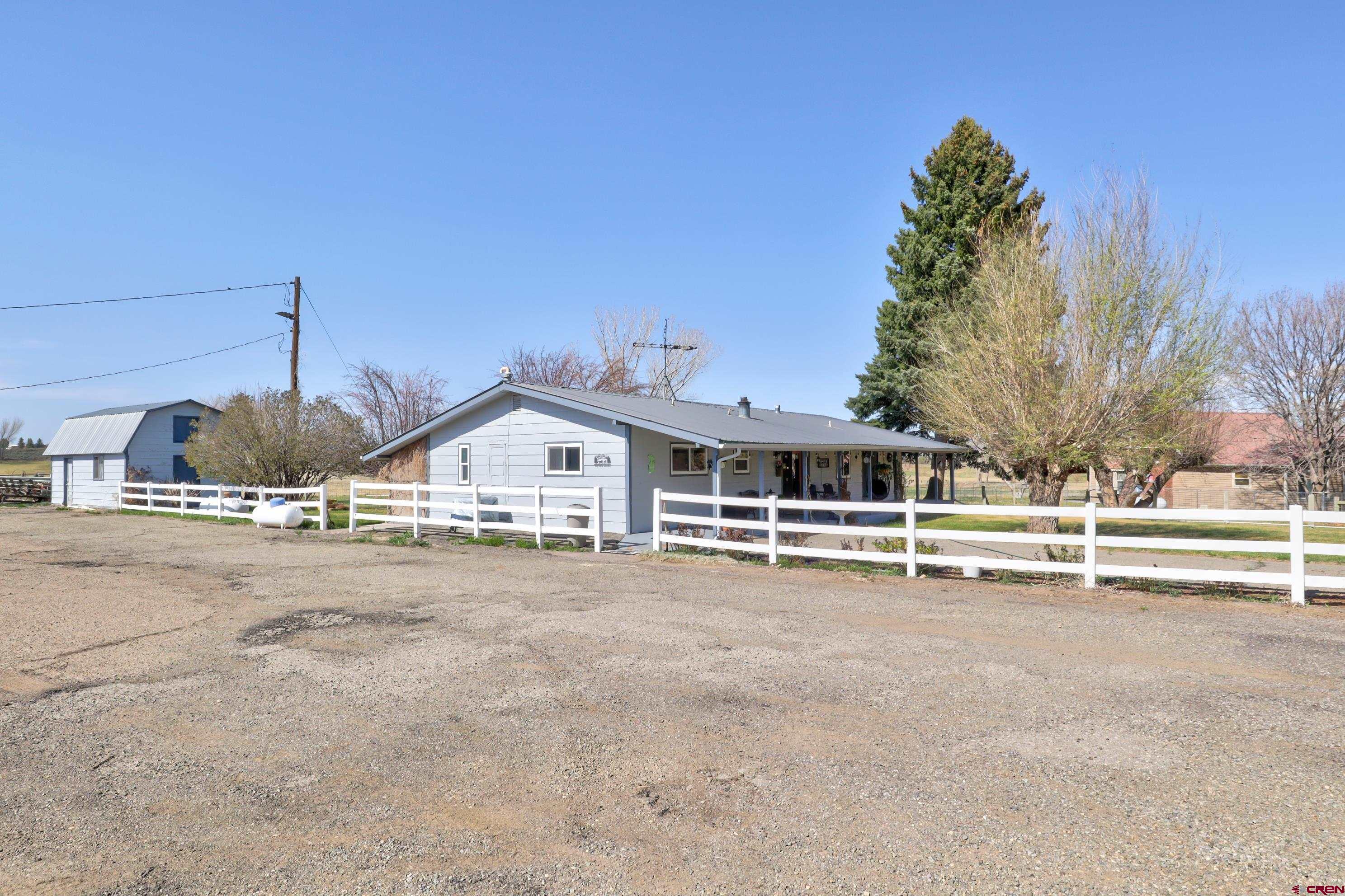 22705 Rd L Cortez, CO 81321 - Photo 2 of 30 a view of a house with a yard and large trees