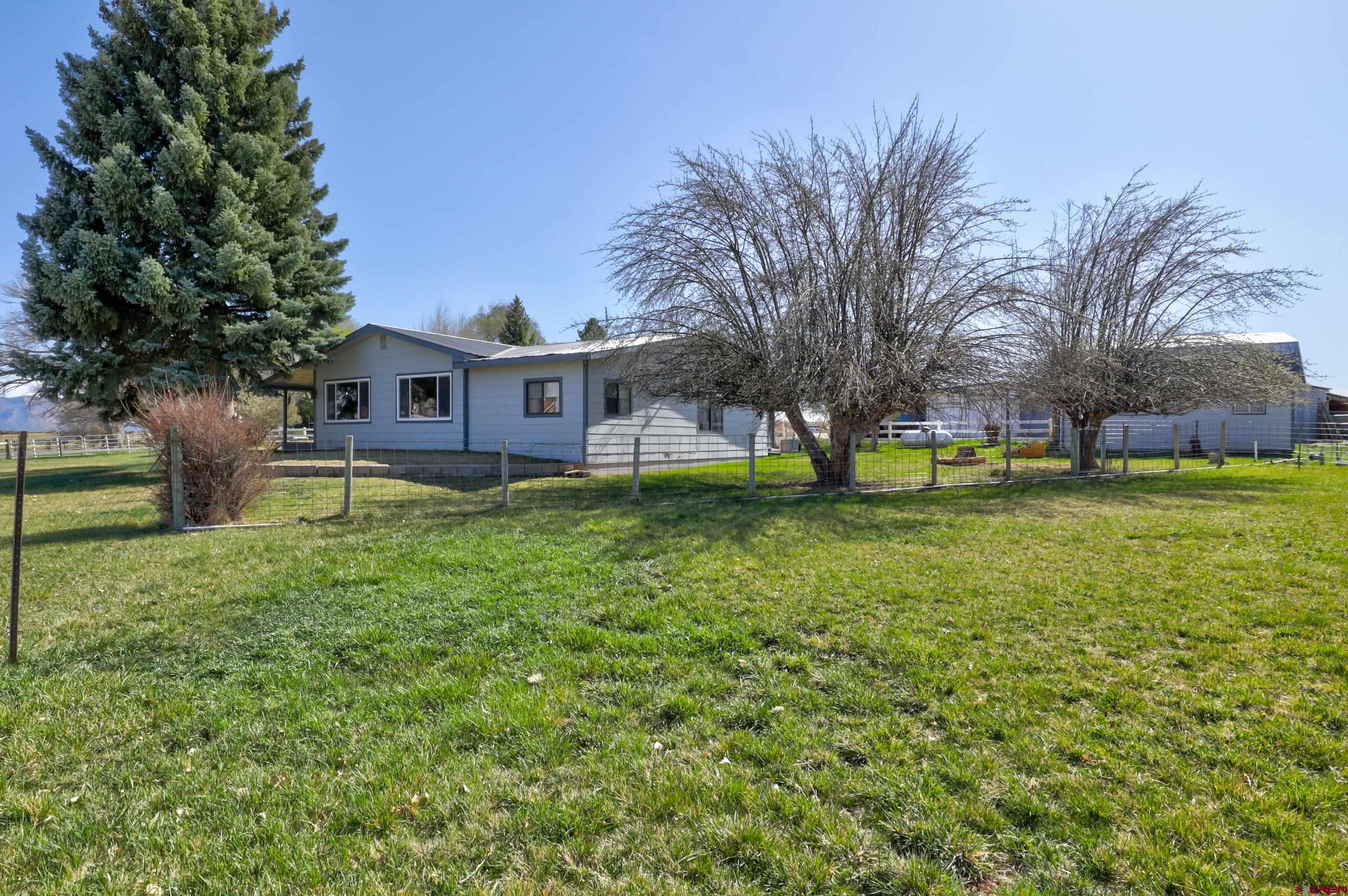 22705 Rd L Cortez, CO 81321 - Photo 25 of 30 a view of a house with a big yard and large trees
