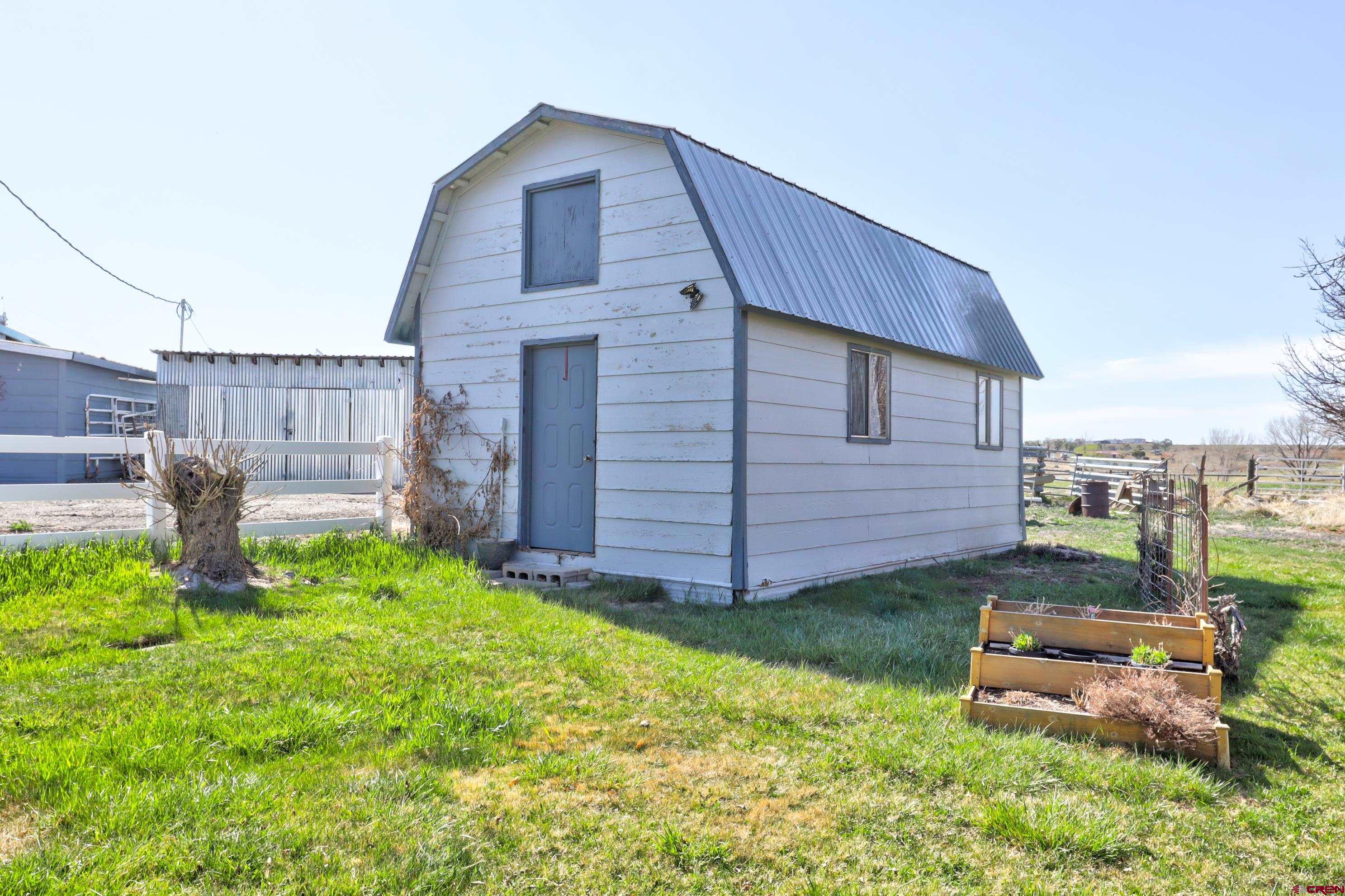22705 Rd L Cortez, CO 81321 - Photo 4 of 30 a backyard of a house with table and chairs