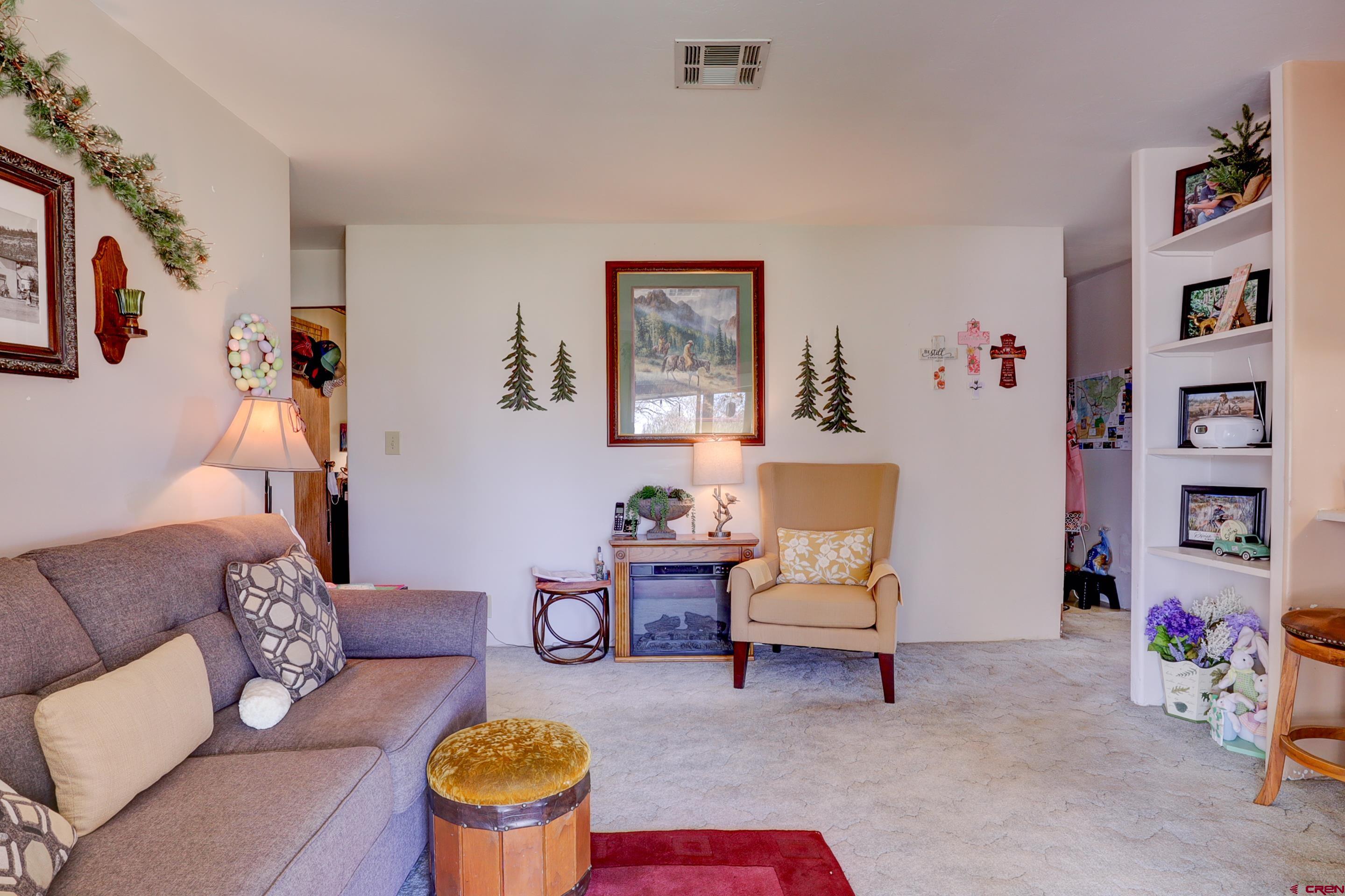 22705 Rd L Cortez, CO 81321 - Photo 5 of 30 a living room with furniture and book shelf