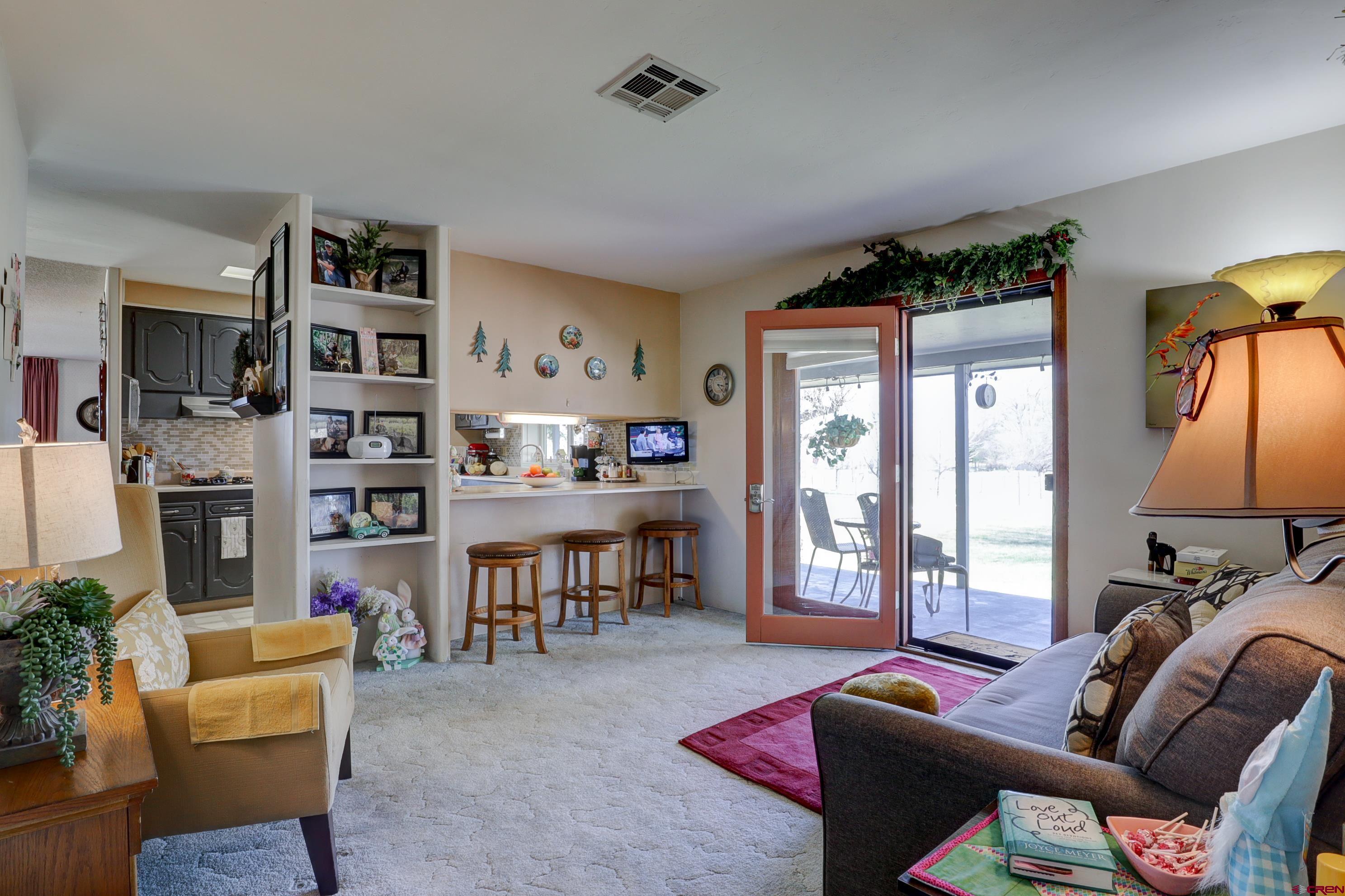 22705 Rd L Cortez, CO 81321 - Photo 7 of 30 a living room with furniture a flat screen tv and a window