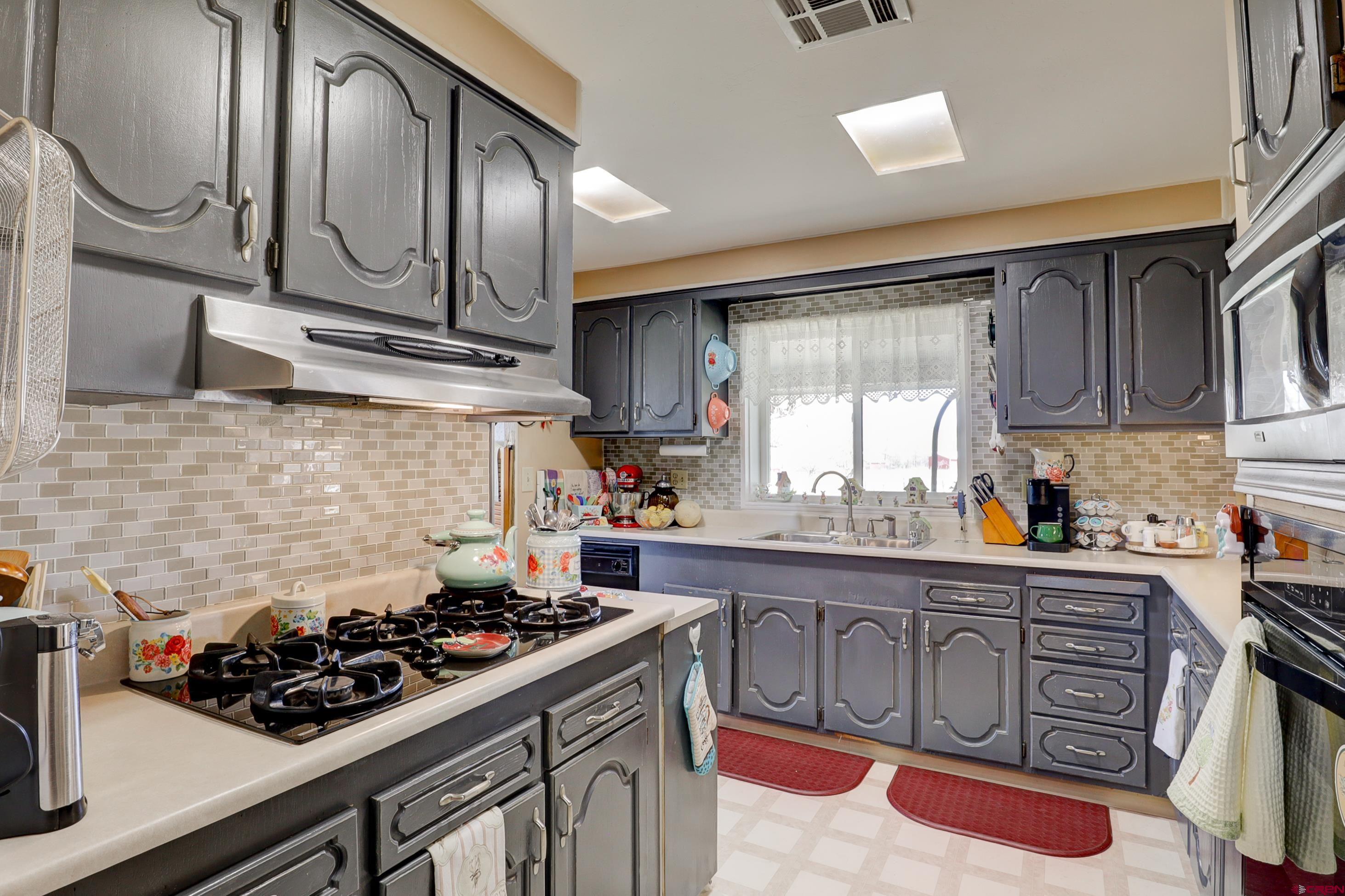 22705 Rd L Cortez, CO 81321 - Photo 9 of 30 a kitchen with stainless steel appliances a stove a sink and cabinets