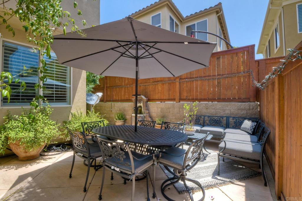 2256 Flatiron Way San Marcos, CA 92078 - Photo 11 of 22 a view of a patio with table and chairs under an umbrella