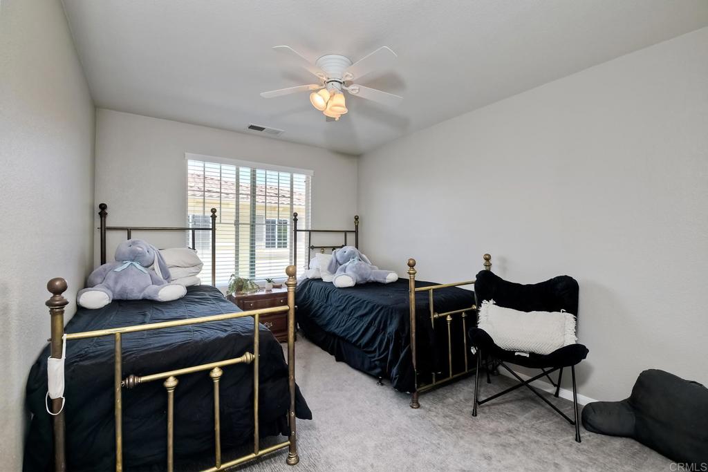 2256 Flatiron Way San Marcos, CA 92078 - Photo 14 of 22 a bed room with furniture and a window