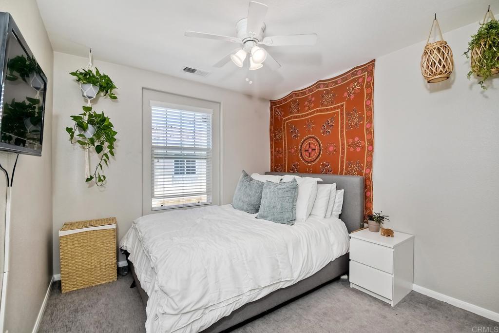 2256 Flatiron Way San Marcos, CA 92078 - Photo 15 of 22 a bedroom with a bed and a potted plant
