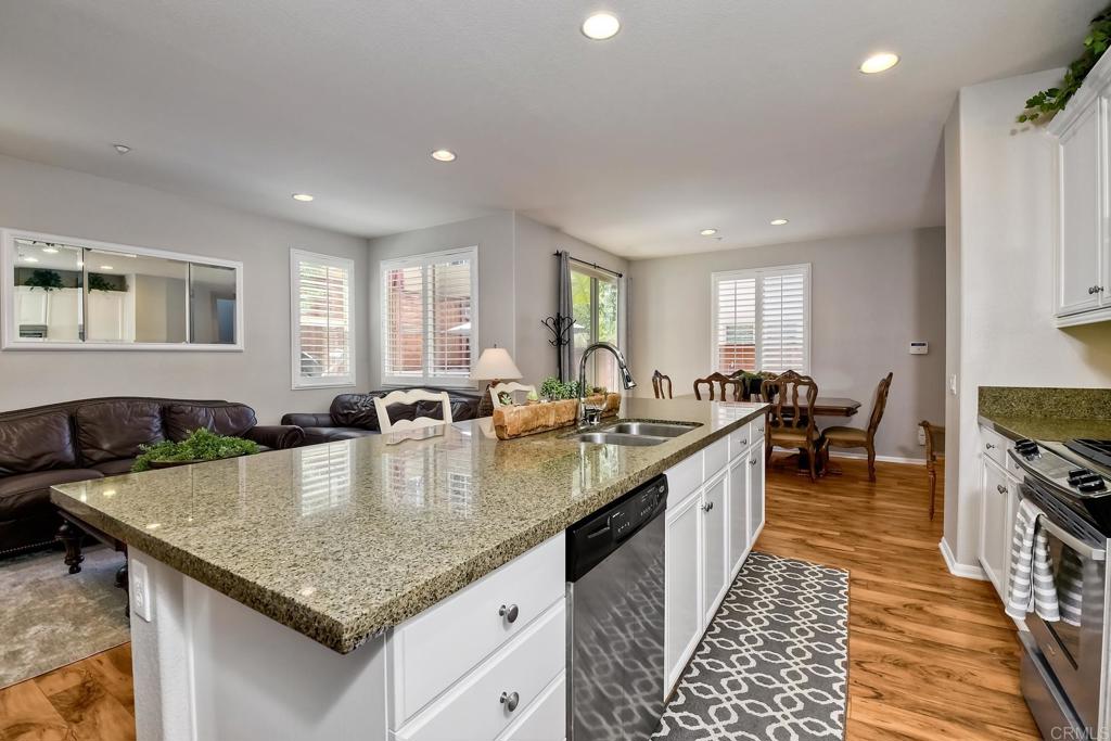 2256 Flatiron Way San Marcos, CA 92078 - Photo 6 of 22 a large kitchen with granite countertop lots of counter space and windows