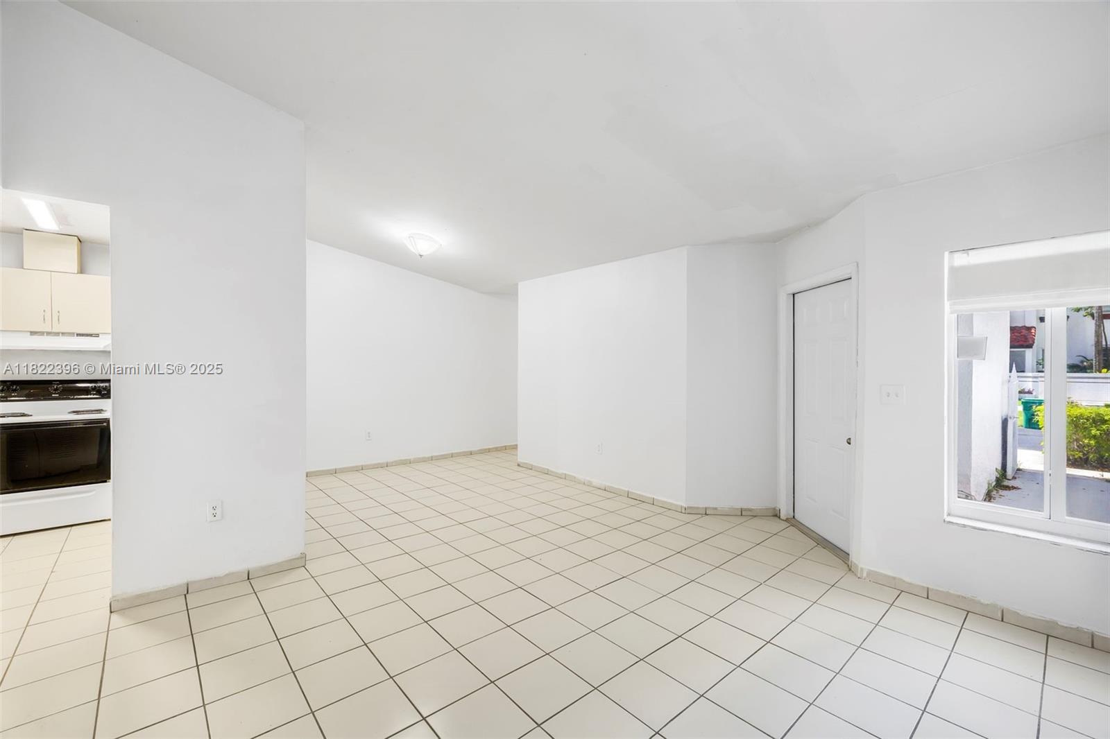 8421 Southwest 209th Street, Unit 8421 Cutler Bay, FL 33189 - Photo 13 of 16 a view of an empty room and window