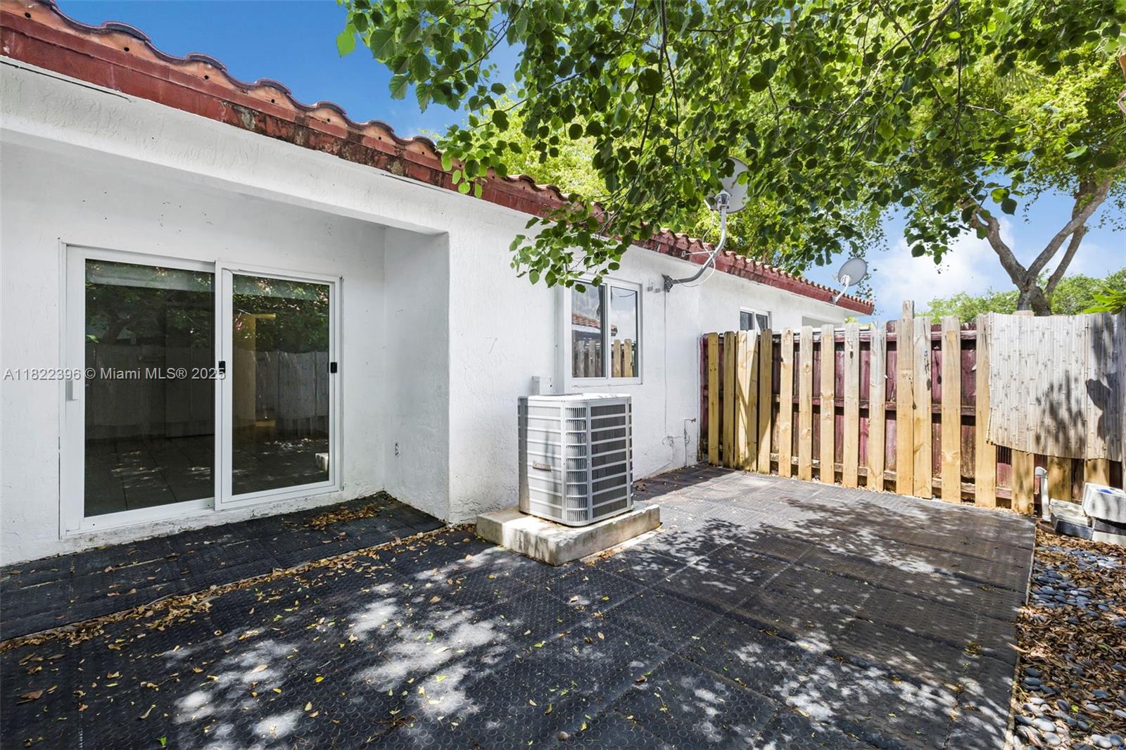 8421 Southwest 209th Street, Unit 8421 Cutler Bay, FL 33189 - Photo 16 of 16 a view of a house with a small yard and large tree