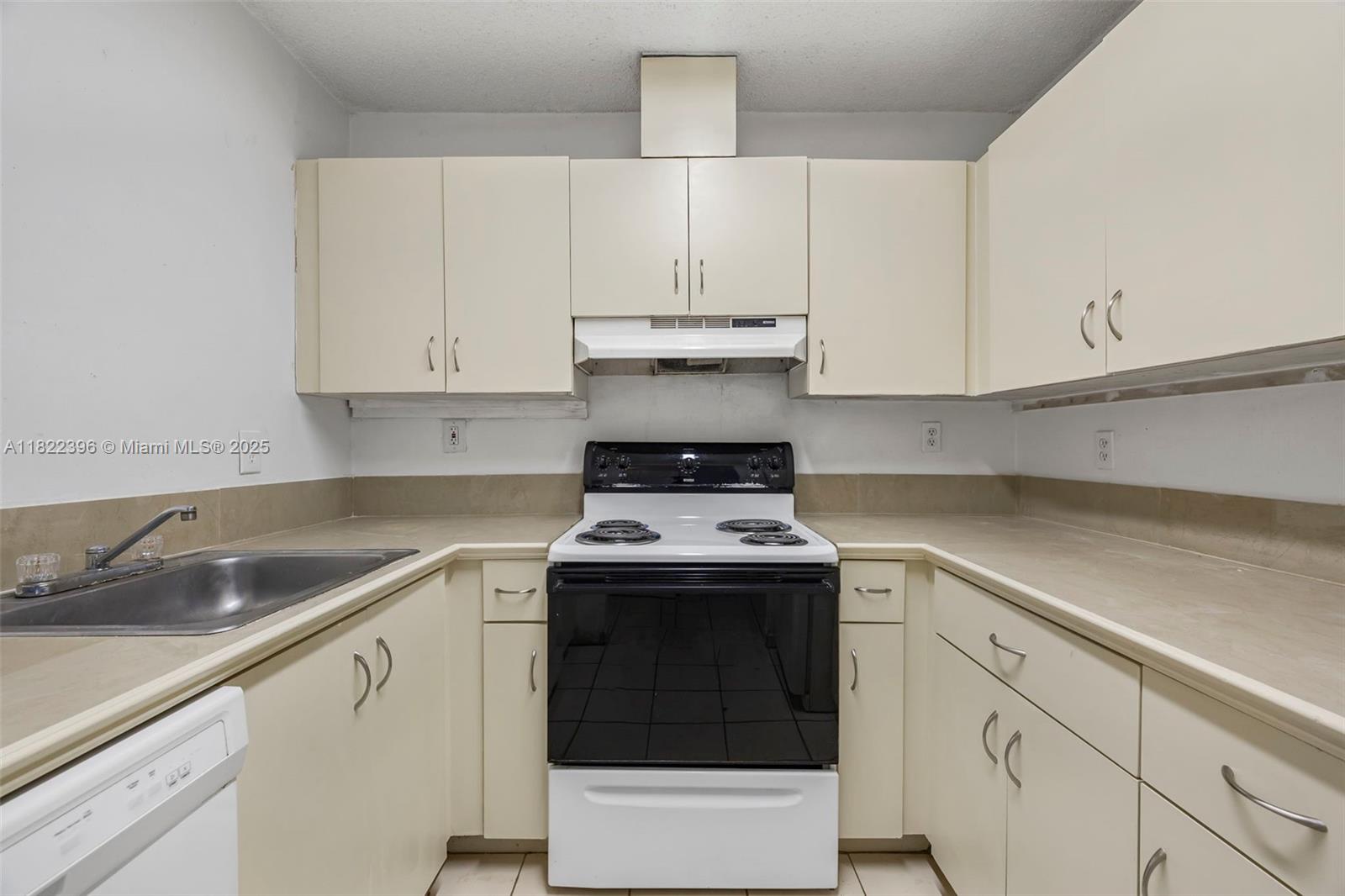 8421 Southwest 209th Street, Unit 8421 Cutler Bay, FL 33189 - Photo 3 of 16 a kitchen with granite countertop white cabinets and white stainless steel appliances
