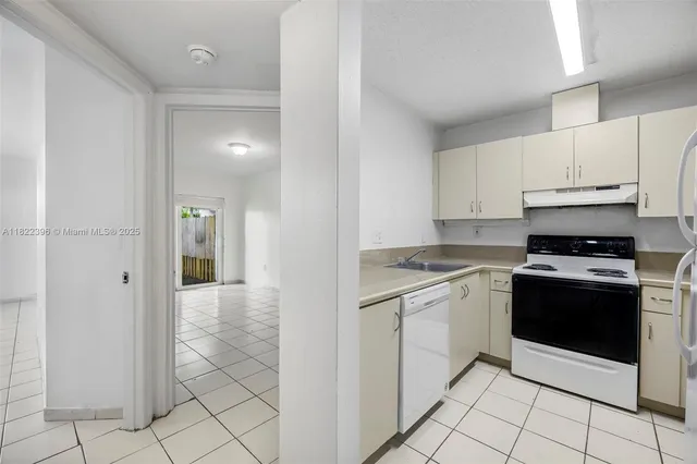 a kitchen with stainless steel appliances granite countertop a stove a refrigerator and a cabinets