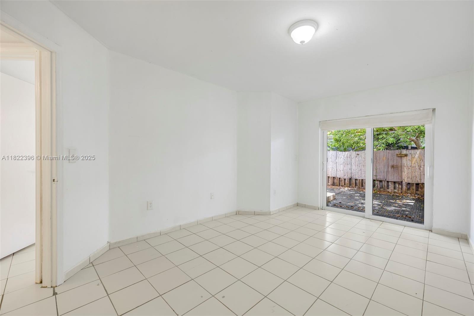 8421 Southwest 209th Street, Unit 8421 Cutler Bay, FL 33189 - Photo 6 of 16 an empty room with windows
