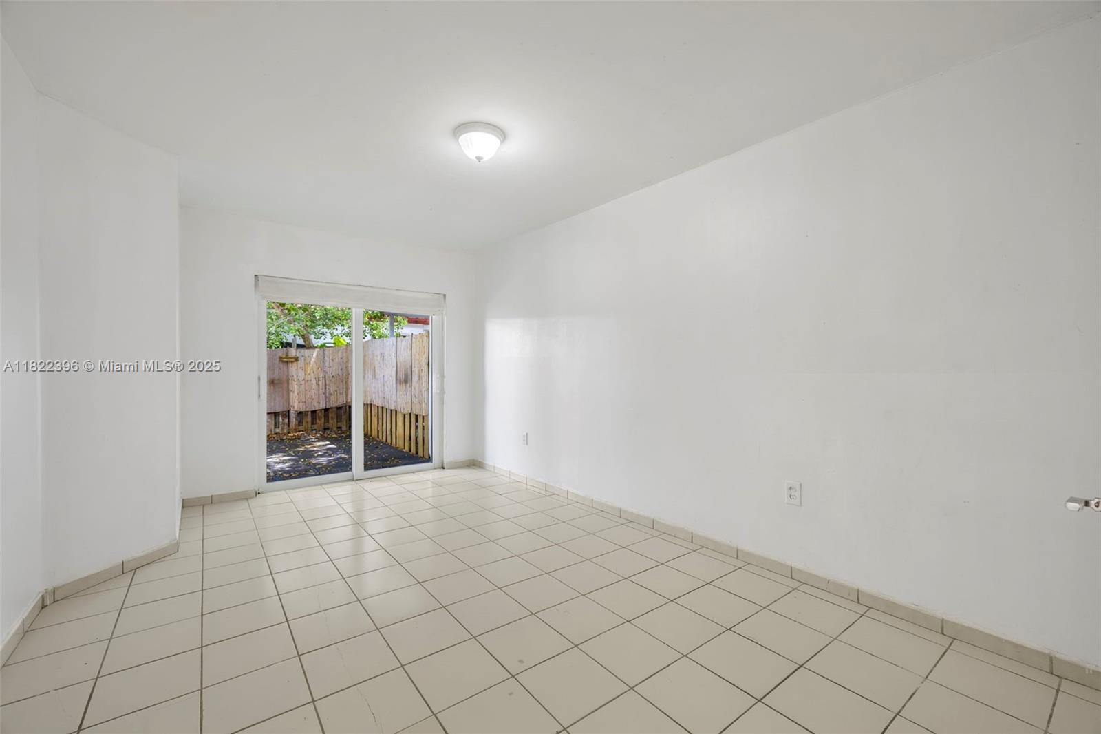 8421 Southwest 209th Street, Unit 8421 Cutler Bay, FL 33189 - Photo 8 of 16 an empty room with windows