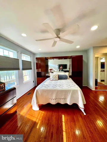 a bedroom with a large bed and a tv