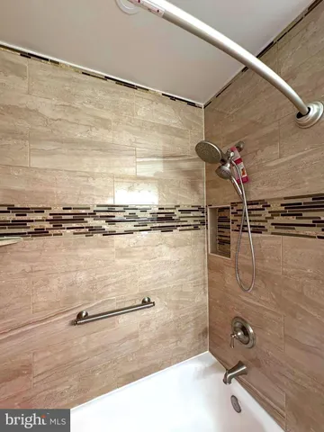 a bathroom with a shower and a sink