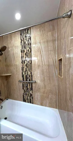 a bathroom with a shower and a tub