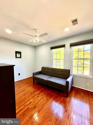 a living room with hard wood floors and a window