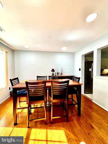 a view of a workspace with furniture and wooden floor