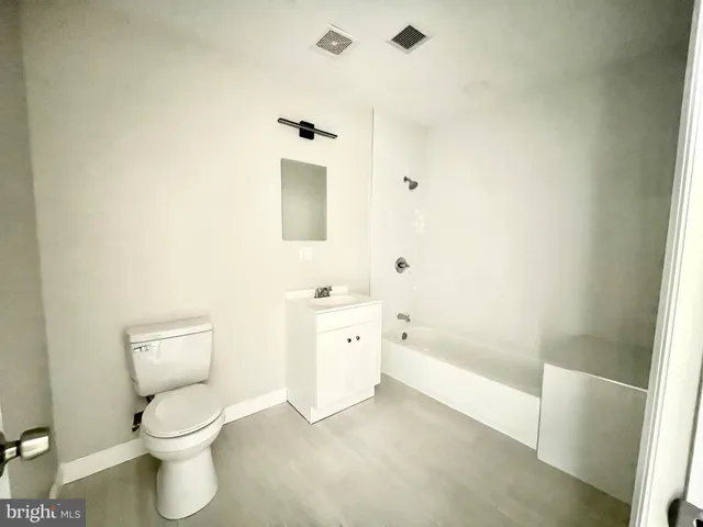 a bathroom with a toilet sink and shower