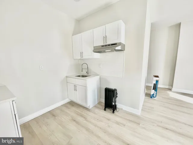 a view of a kitchen with sink and cabinets