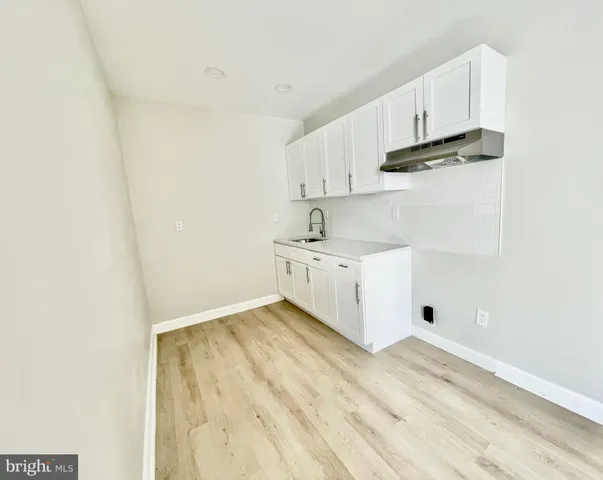 a view of kitchen with white cabinets