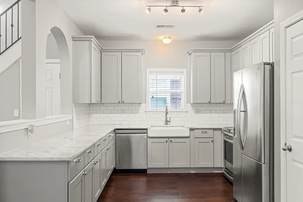 a kitchen with a sink stove and refrigerator