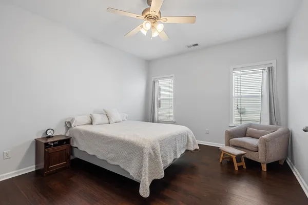 a bedroom with a bed and a chandelier