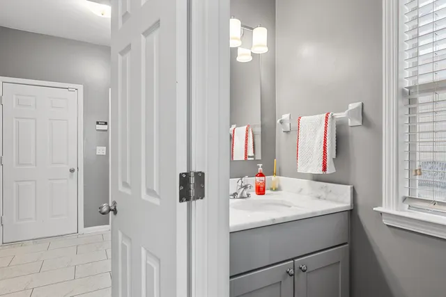 a bathroom with a sink and a mirror