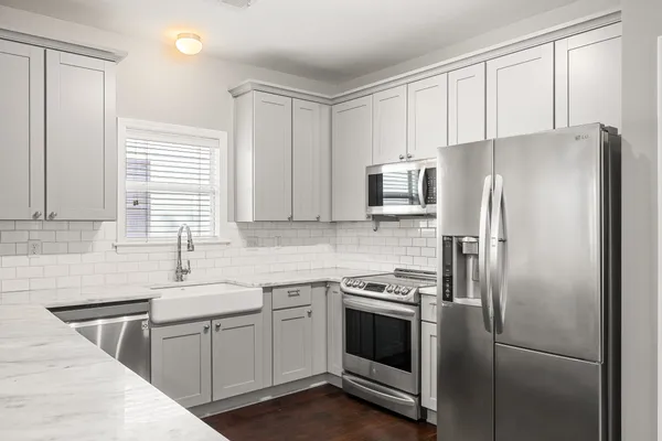 a kitchen with a refrigerator sink and microwave