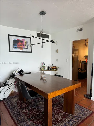 a view of a workspace with furniture and clutter