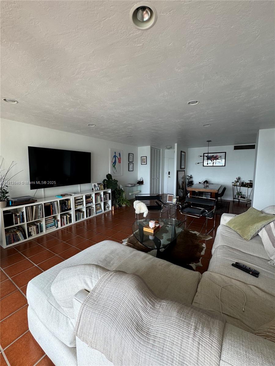 2451 Brickell Avenue, Unit 16U Miami, FL 33129 - Photo 15 of 17 a living room with furniture and a flat screen tv