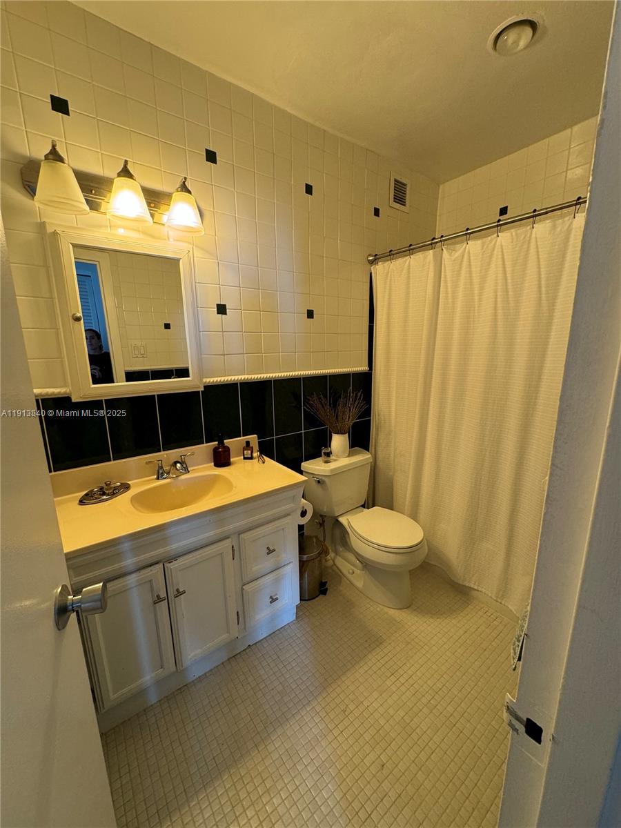 2451 Brickell Avenue, Unit 16U Miami, FL 33129 - Photo 16 of 17 a bathroom with a sink a toilet and shower