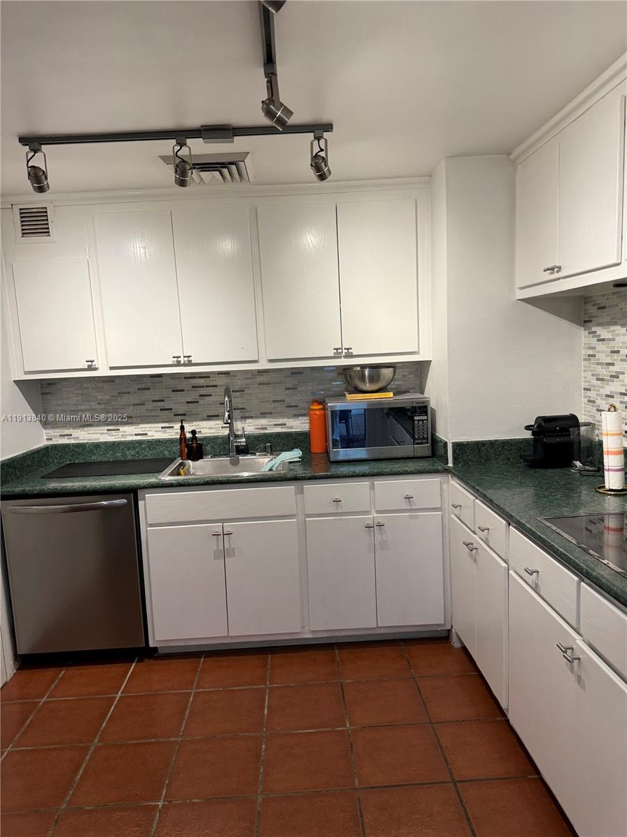 2451 Brickell Avenue, Unit 16U Miami, FL 33129 - Photo 10 of 17 a kitchen with a sink and cabinets