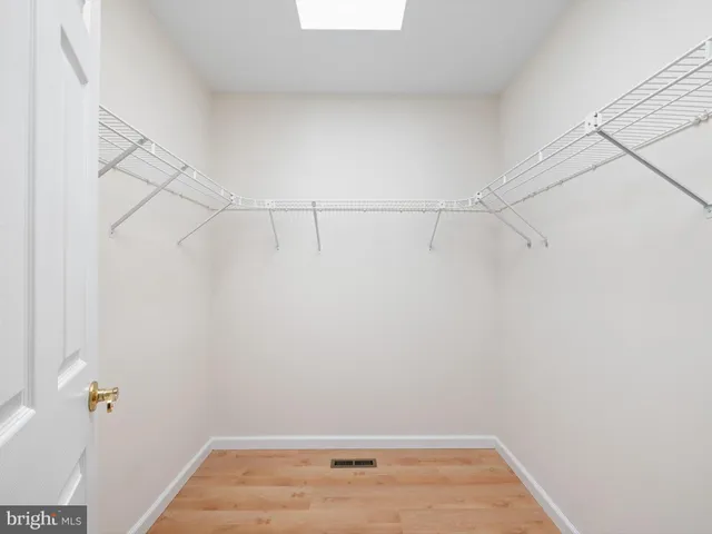 a view of a hallway with a ceiling fan