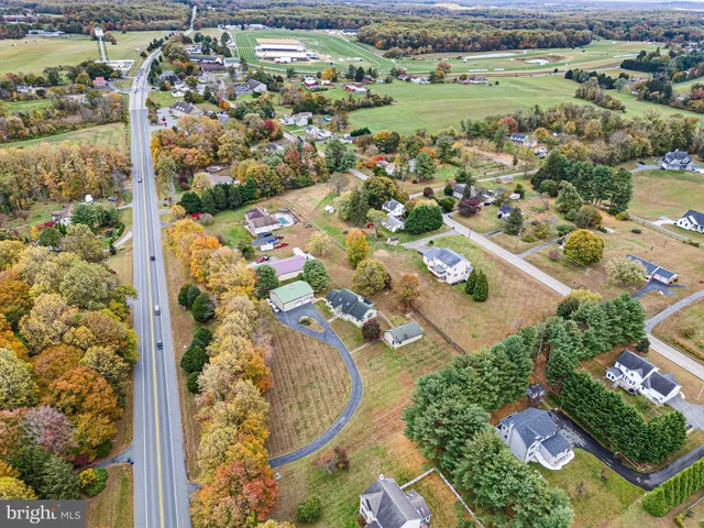 a view of a house with a yard and mountain view in back