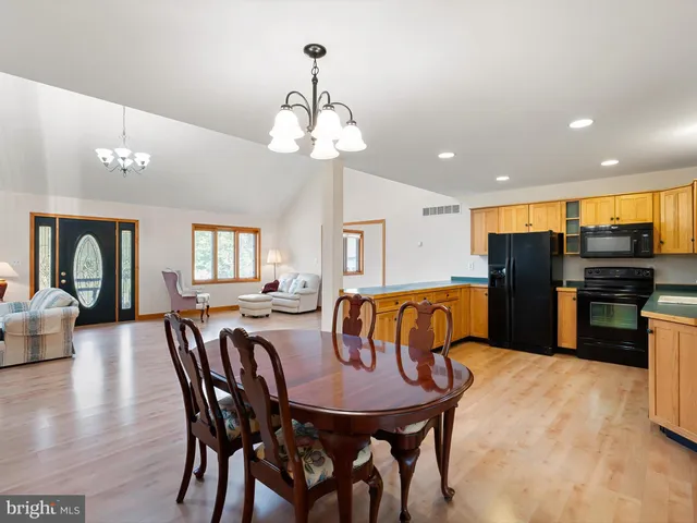 a view of a house with a big yard and large trees