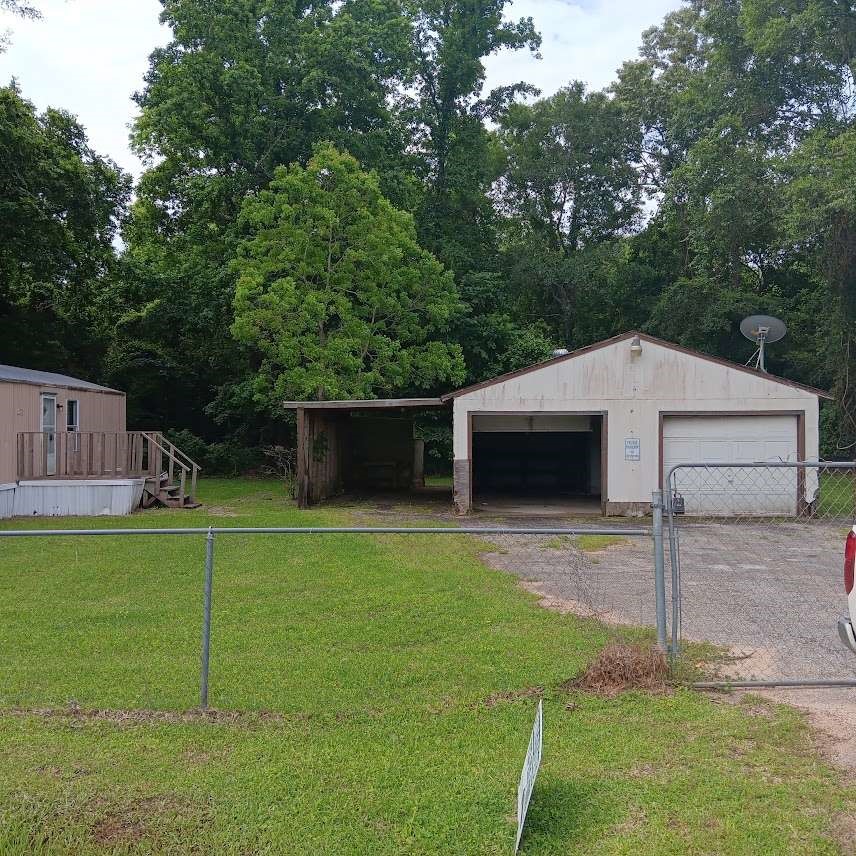 368 Pine Ridge Drive Cleveland, TX 77327 - Photo 2 of 27 a backyard of a house with table and chairs