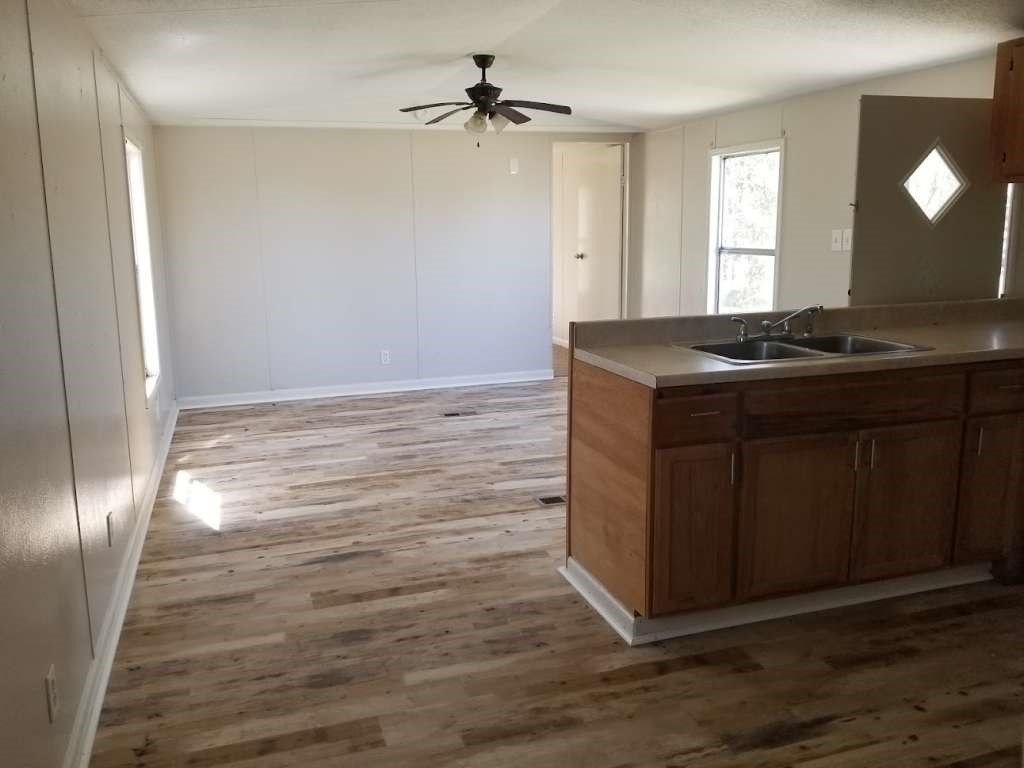 368 Pine Ridge Drive Cleveland, TX 77327 - Photo 5 of 27 a view of a kitchen cabinets and a wooden floor