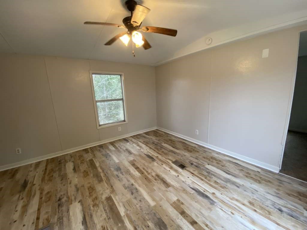 368 Pine Ridge Drive Cleveland, TX 77327 - Photo 8 of 27 wooden floor in an empty room with a window