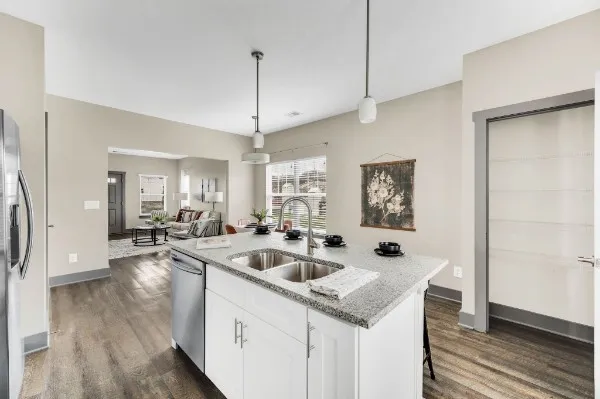 a open kitchen with stainless steel appliances granite countertop a sink and a refrigerator