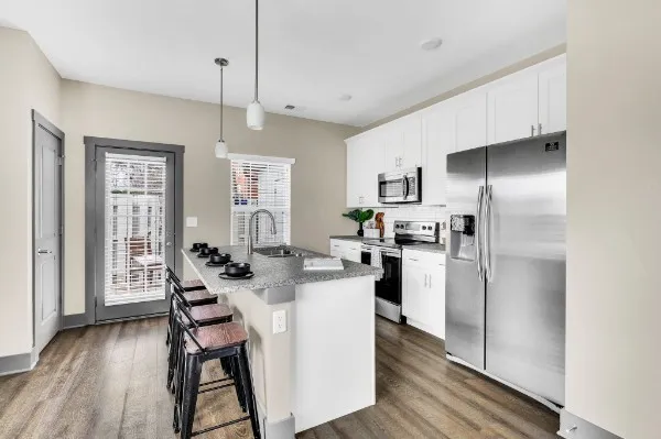 a kitchen with refrigerator and cabinets
