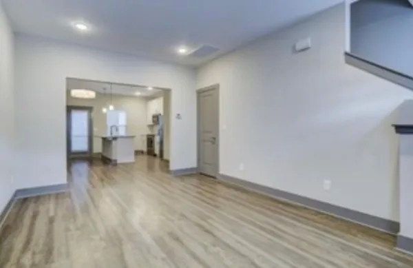 a view of a room with wooden floor