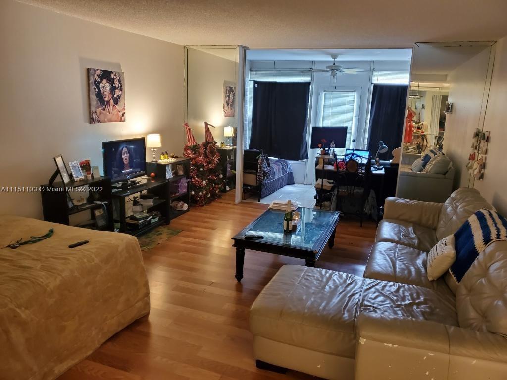 3660 Inverrary Drive, Unit 1R Lauderhill, FL 33319 - Photo 2 of 15 a living room with furniture and a wooden floor