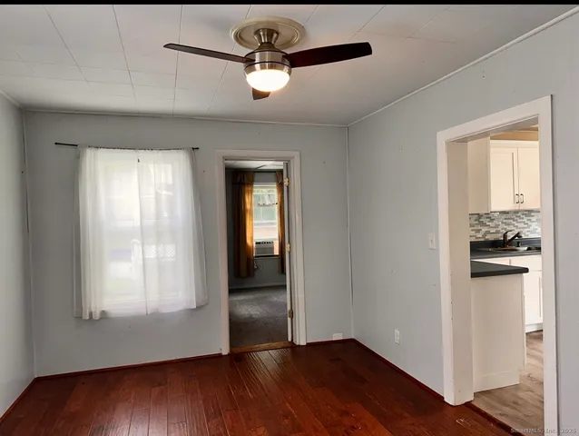 a view of a kitchen cabinets a stove and wooden floor