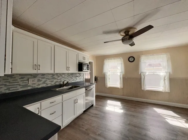 a kitchen with stainless steel appliances granite countertop a stove and a refrigerator